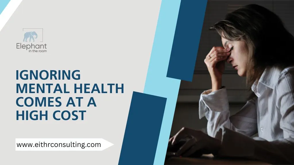 Stressed employee holding head at desk highlighting mental health challenges at work