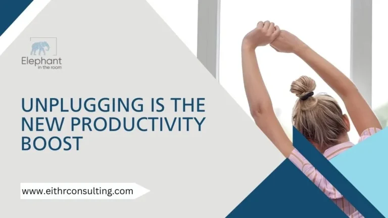 Employee stretching by a window symbolizing unplugging for better focus and productivity