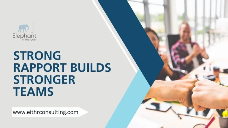 Team members fist-bumping in an office meeting, symbolizing strong rapport, teamwork, collaboration, and positive workplace culture.