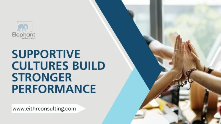 Team members high-fiving in an office representing supportive workplace culture and strong team performance.